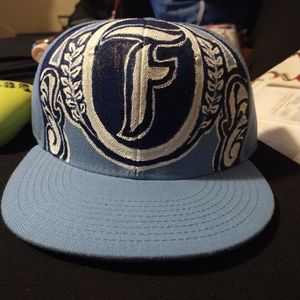 Custom painted blue hat with an f in the middle leaf border